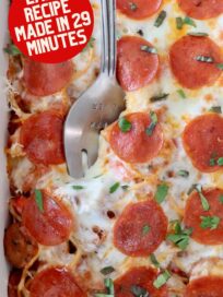 pizza baked spaghetti in casserole dish with large serving fork