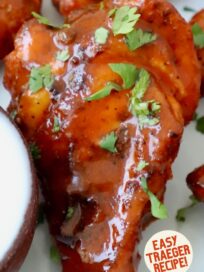 smoked chicken wings tossed with buffalo sauce on plate