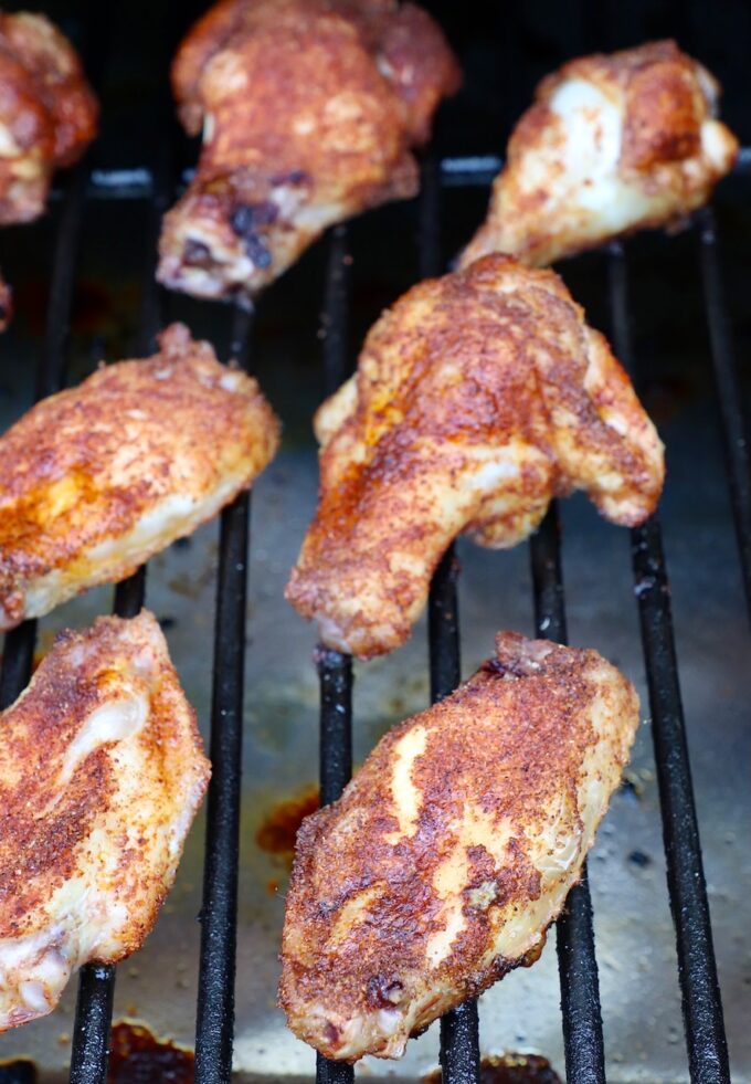 cooked, seasoned chicken wings on smoker