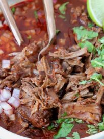 shredded beef birria in bowl with broth