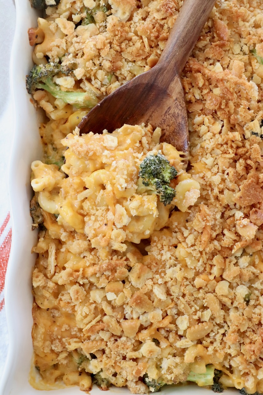 baked mac and cheese in casserole dish with serving spoon