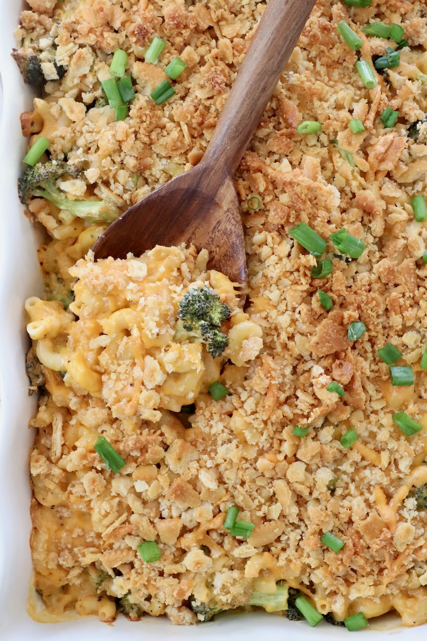 baked broccoli mac and cheese in casserole dish with serving spoon