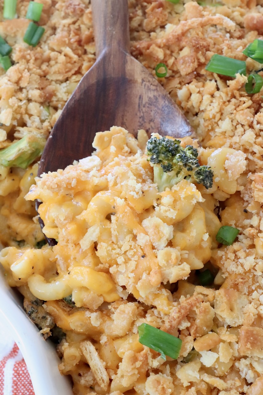 baked broccoli mac and cheese in casserole dish with large serving spoon