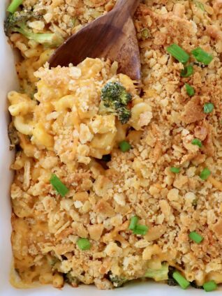 broccoli mac and cheese in casserole dish with serving spoon