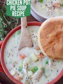 chicken pot pie soup in bowls, topped with a biscuit