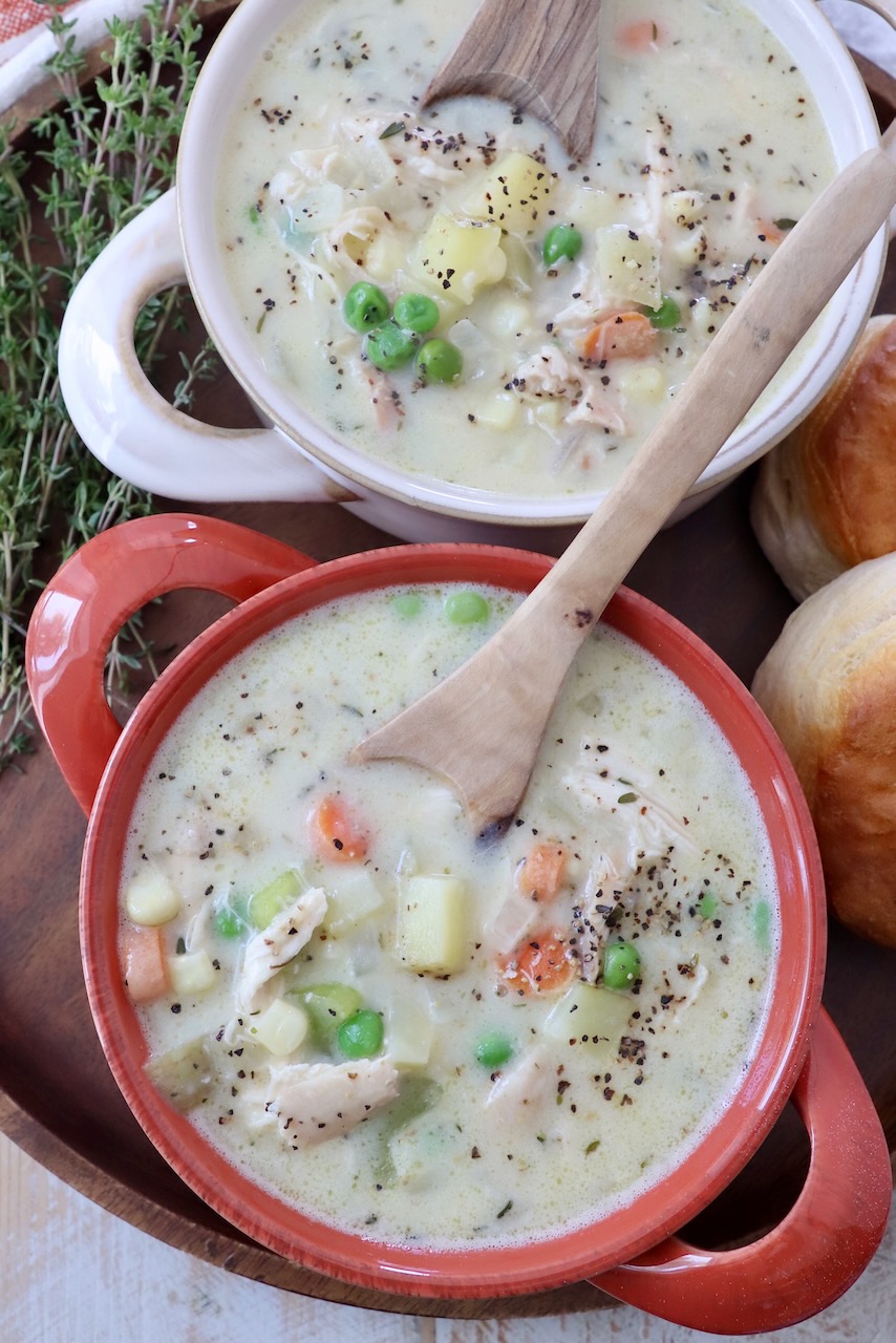 chicken pot pie soup in bowls with spoons