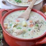 chicken pot pie soup in bowl with spoon