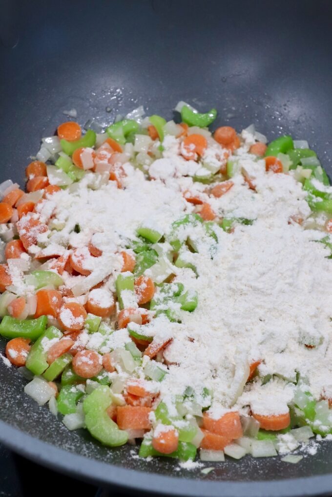 flour on top of diced vegetables in skillet