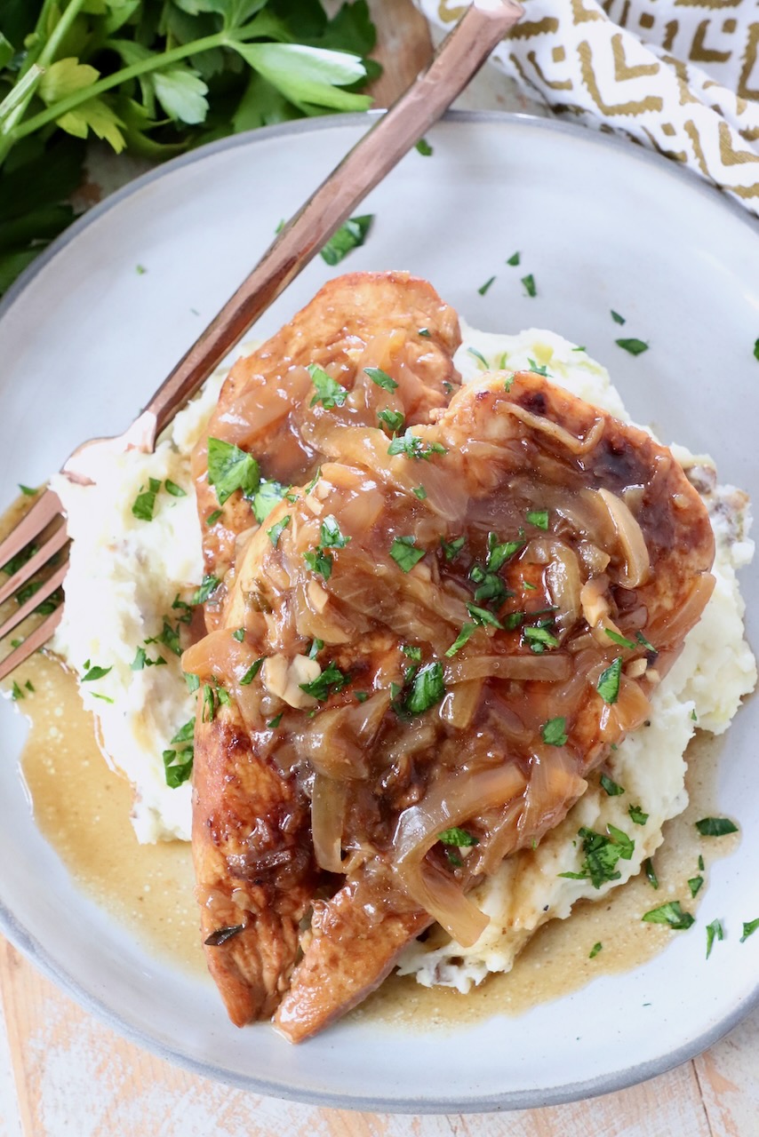 cooked chicken breast on plate with mashed potatoes