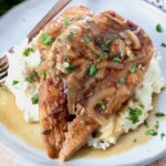 cooked french onion chicken breasts on plate with mashed potatoes