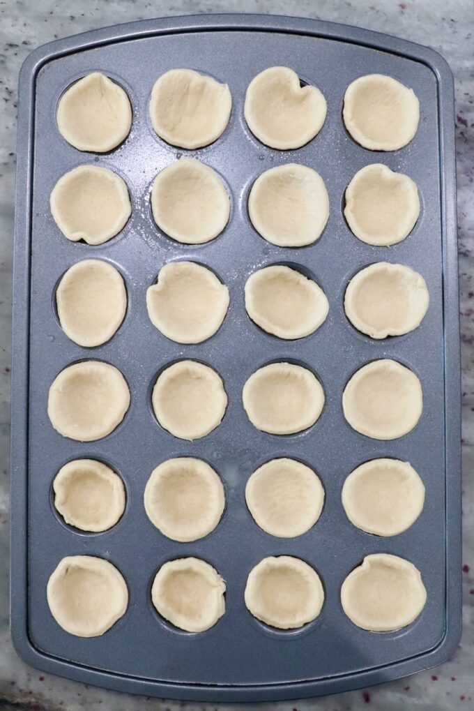 crescent roll dough rounds in mini muffin tin