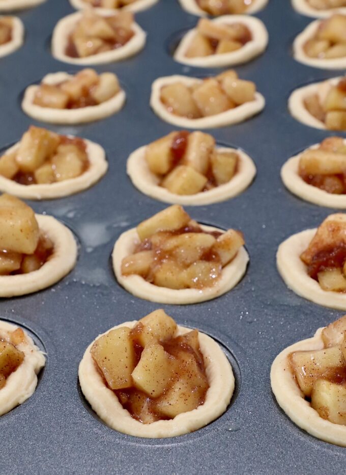 unbaked mini apple pies in mini muffin tin