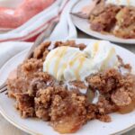 baked apple dump cake on plate with ice cream