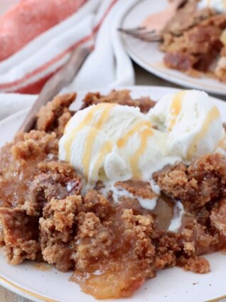 baked apple dump cake on plate with ice cream