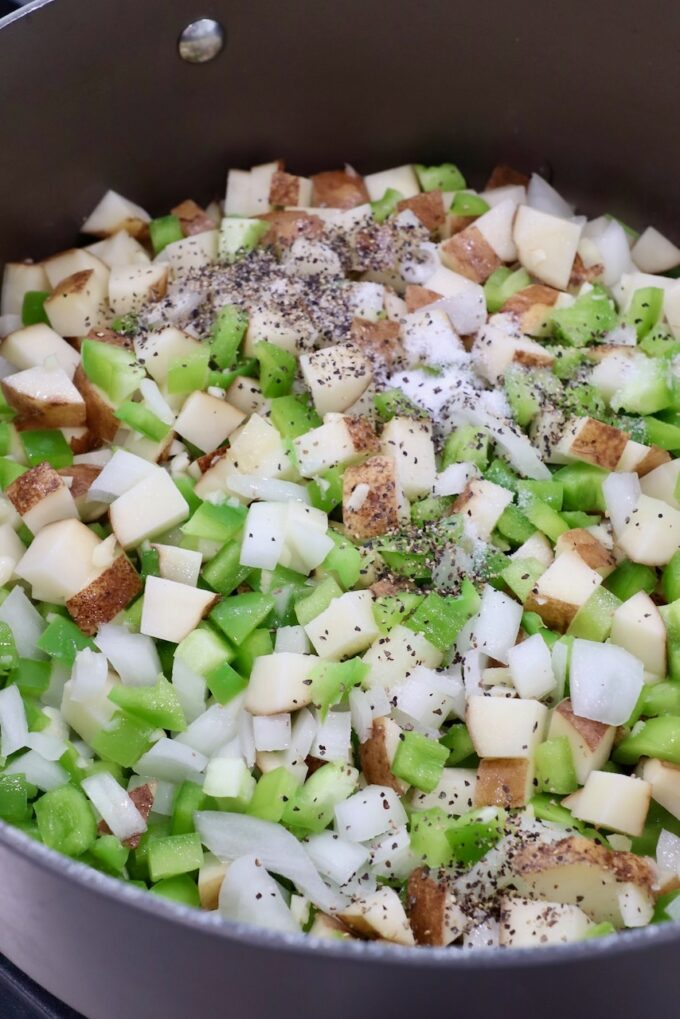 seasoned diced potatoes and vegetables in dutch oven