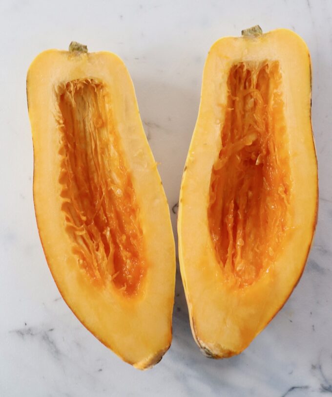 delicata squash cut in half with the seeds removed