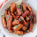 roasted honey glazed carrots in bowl with spoon