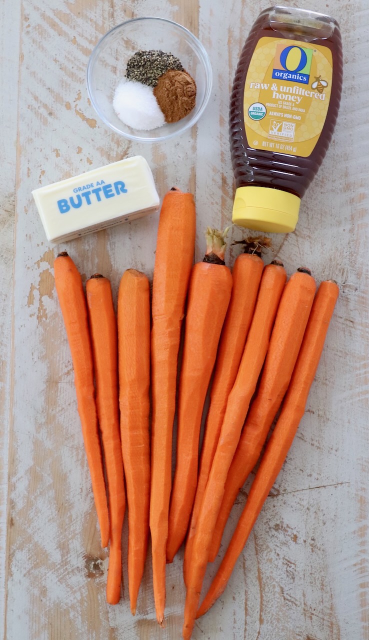 honey glazed carrot ingredients on white wood board
