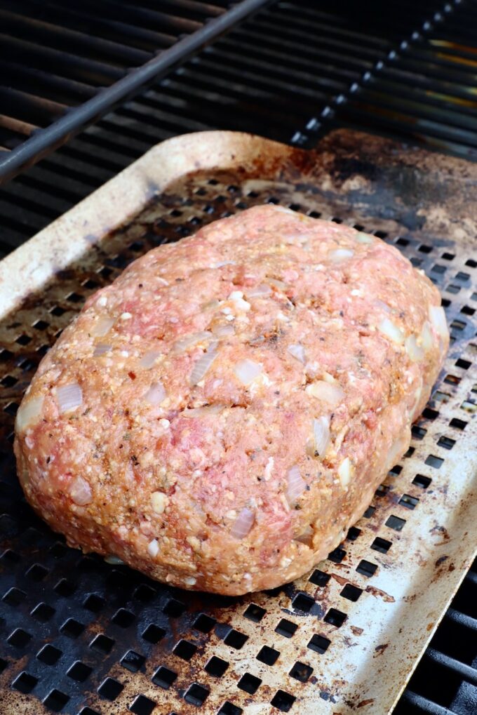 uncooked meatloaf on grill pan in smoker