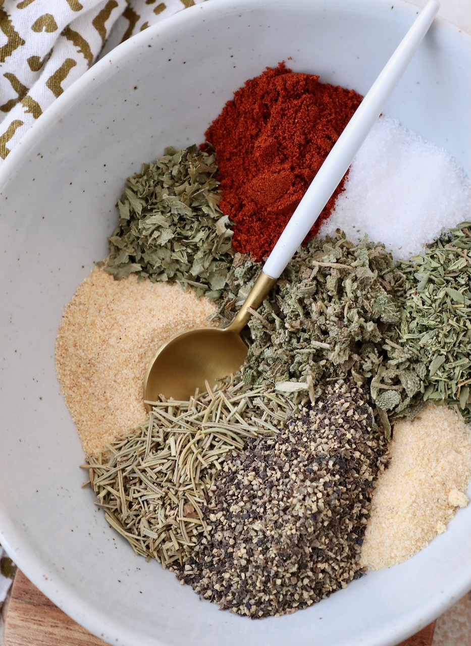 herbs and spices separated in bowl with spoon