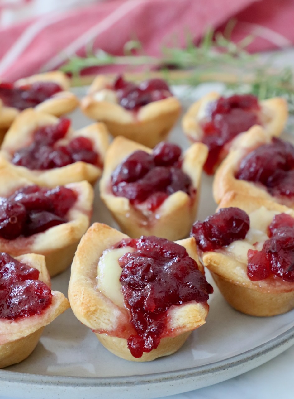 baked brie bites topped with cranberry sauce on plate