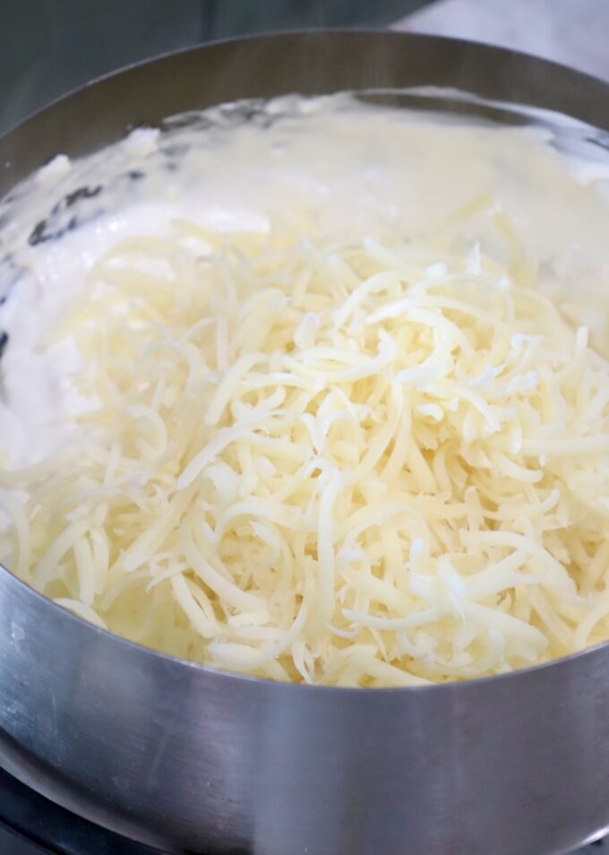 shredded swiss cheese in fondue pot