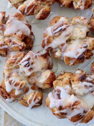 pull apart cinnamon rolls on plate topped with cream cheese icing