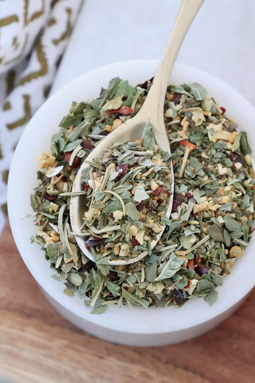 Italian seasoning in a bowl with a spoon