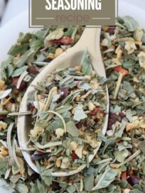 dried herbs and spices mixed together in a bowl with a spoon