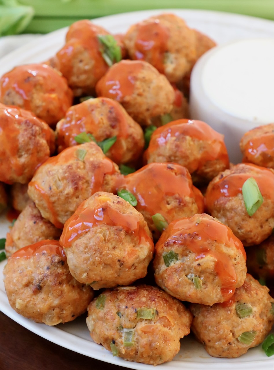 meatballs on plate drizzled with buffalo sauce