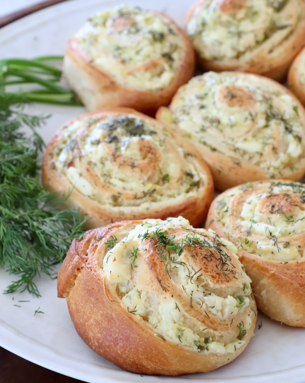 creamy pickle crescent rolls on plate with fresh dill