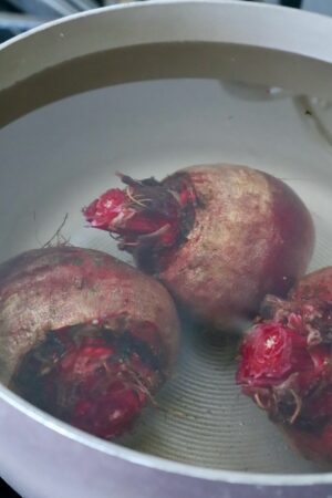 raw beets covered in water in a pot