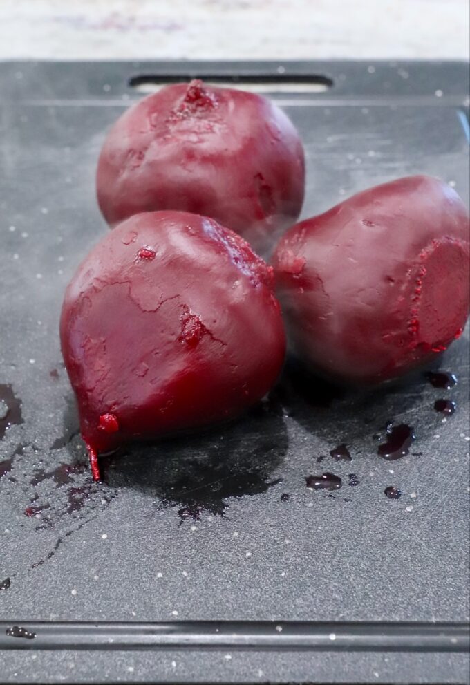 steamed beets on cutting board