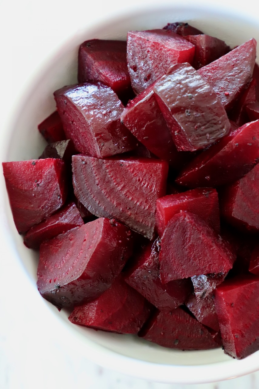 cooked diced beets in a white bowl