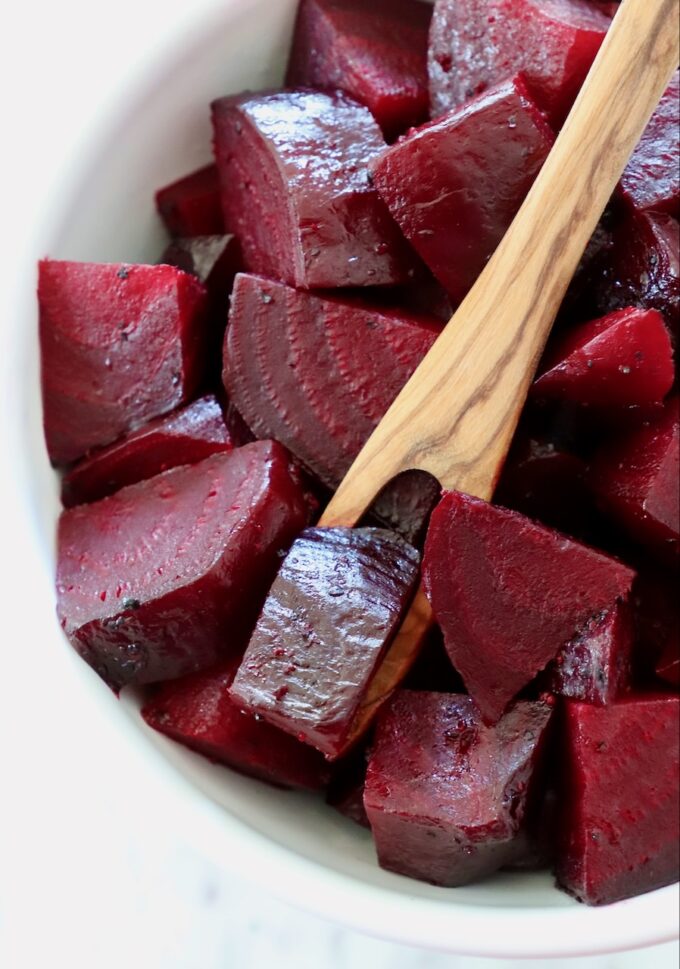diced cooked beets in a bowl with wooden fork