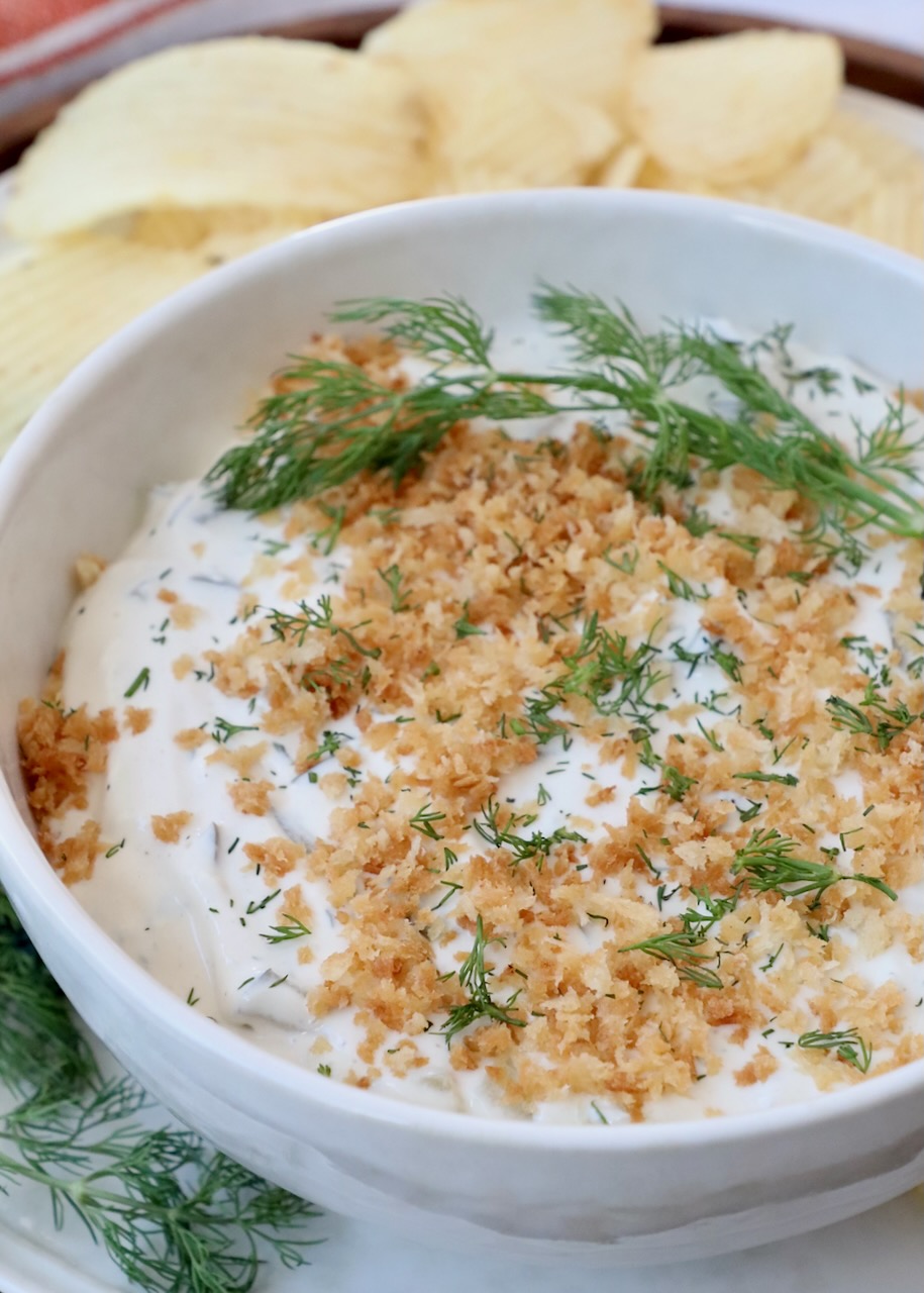 dill pickle dip in bowl topped with toasted breadcrumbs
