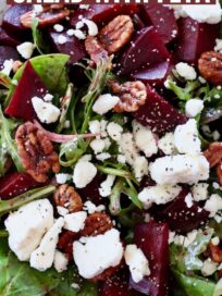 beet salad in bowl topped with pecans, feta cheese crumbles and pears