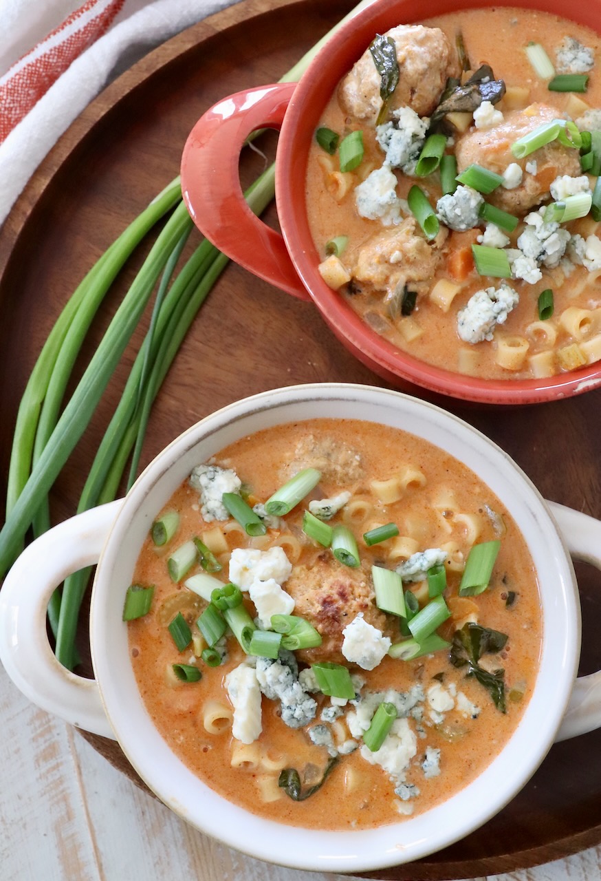 buffalo chicken soup in bowls with green onions