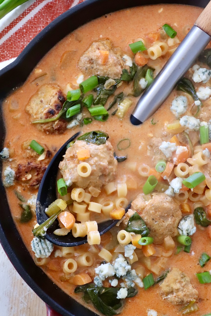buffalo chicken meatball soup in skillet with serving spoon