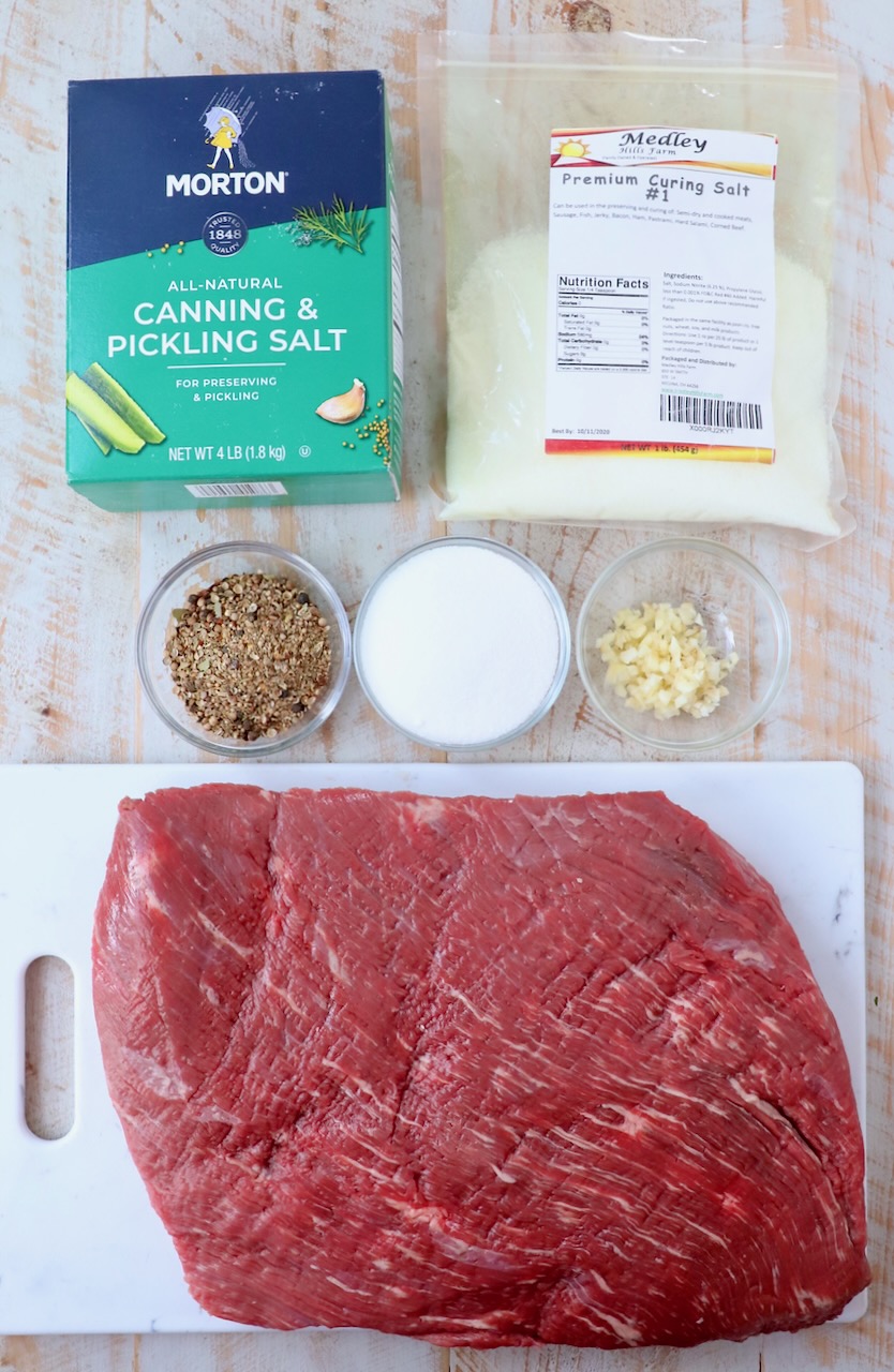ingredients for homemade corned beef on white wood board