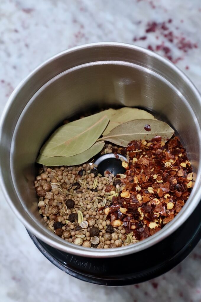 spices and bay leaves in spice grinder