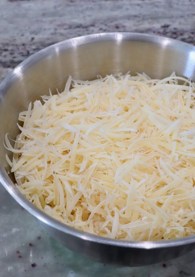 grated parmesan and gruyere cheese in a metal bowl