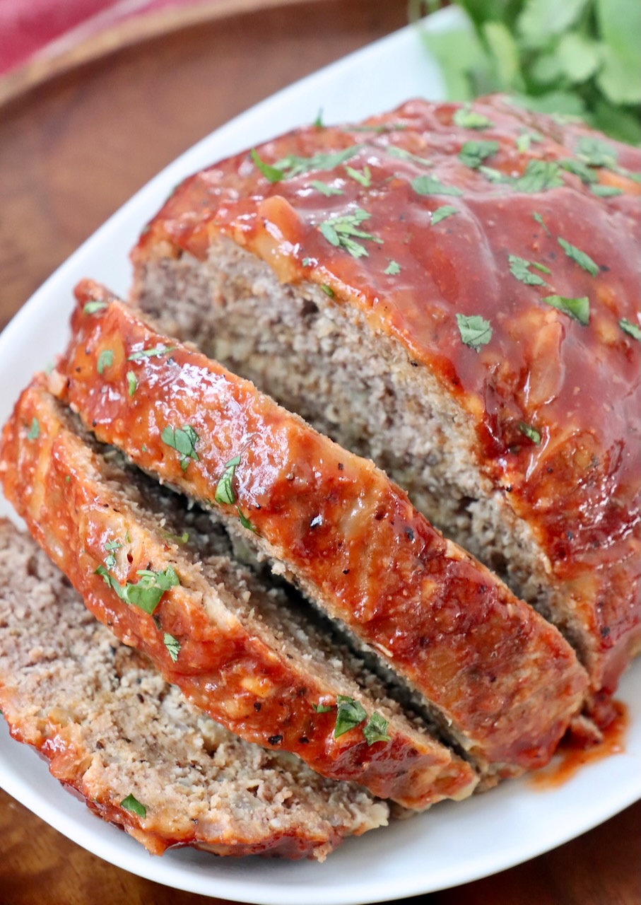 meatloaf sliced on plate with fresh parsley