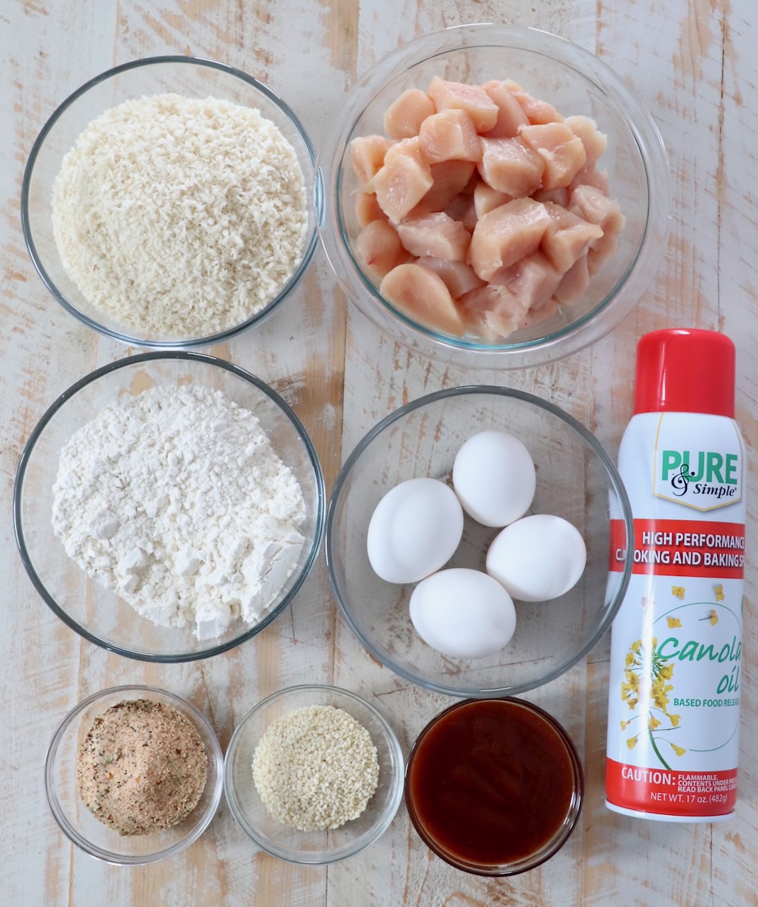 ingredients for jack daniels sesame chicken strips recipe on white wood board