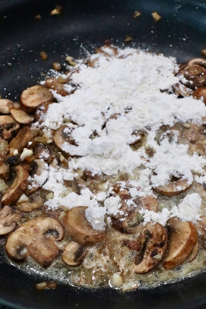 mushrooms covered in flour in skillet