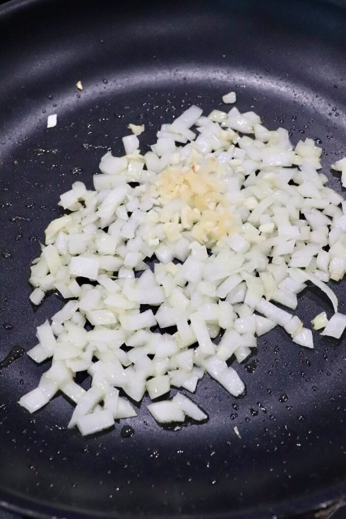 diced onions and garlic in skillet