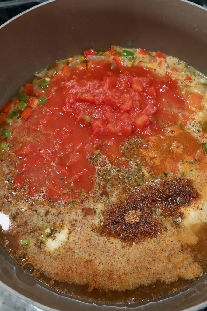 diced vegetables, tomatoes and spices in a pot on the stove