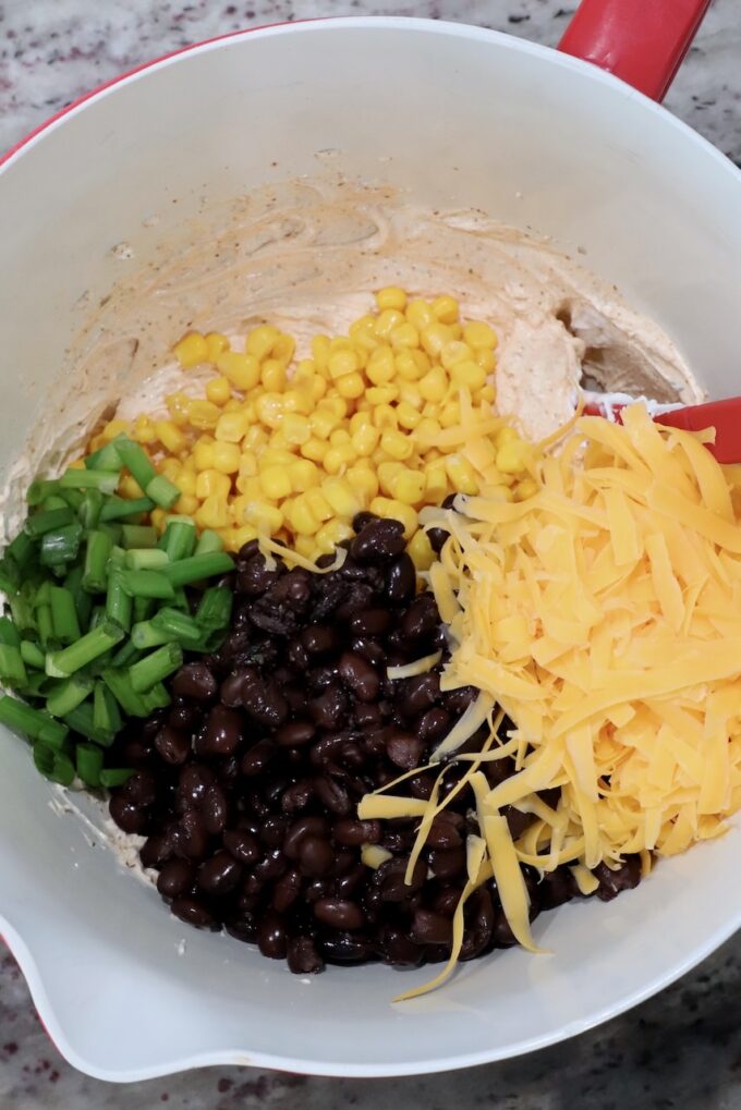 black beans, corn, green onions and shredded cheddar cheese in large bowl