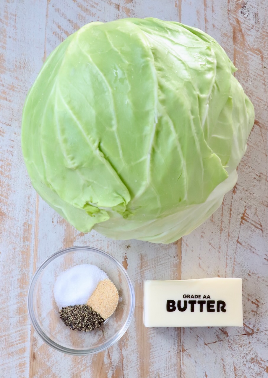 ingredients for steamed cabbage on a white wood board