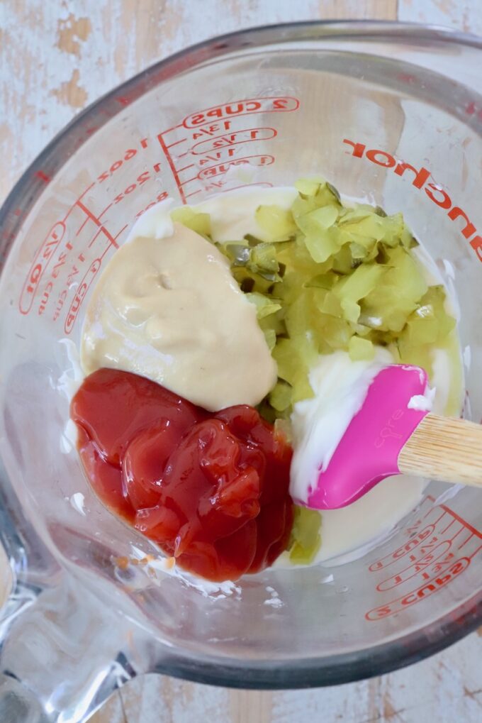 ketchup, dijon mustard, mayonnaise and finely diced pickles in a glass jar